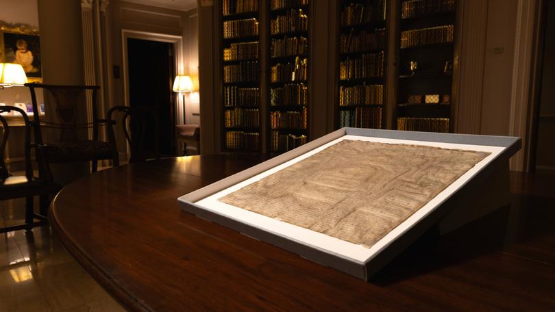 This photo provided by Harvard Law School shows a rare copy of the Magna Carta from 1300 sits in a display case on April 15, 2025, at Harvard Law School in Cambridge, Mass. (Lorin Granger/Harvard Law School via AP)