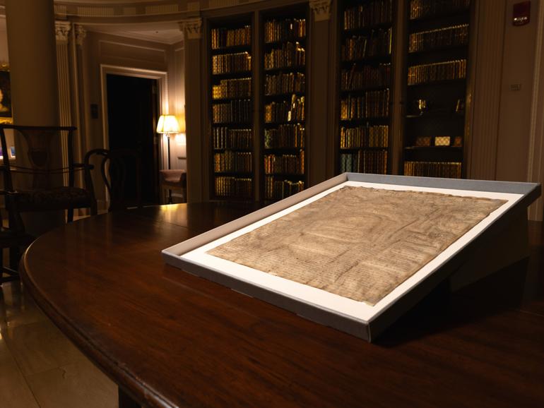 This photo provided by Harvard Law School shows a rare copy of the Magna Carta from 1300 sits in a display case on April 15, 2025, at Harvard Law School in Cambridge, Mass. (Lorin Granger/Harvard Law School via AP)