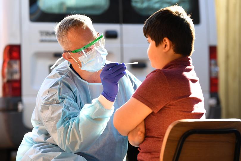 Nurse Wayne Kalep from Knox Private Hospital conducts a coronavirus test in Hallam, Melbourne, in 2020.