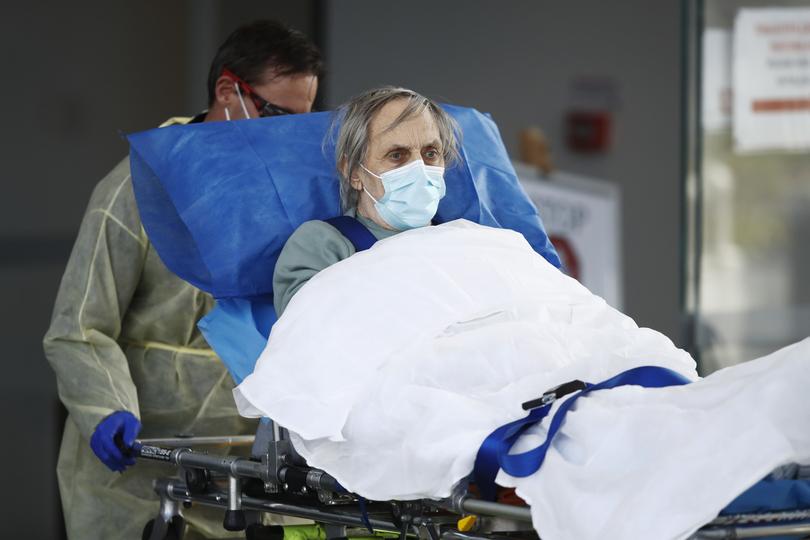 A resident is taken away in an ambulance from Epping Gardens Aged Care Facility in Melbourne in 2020.