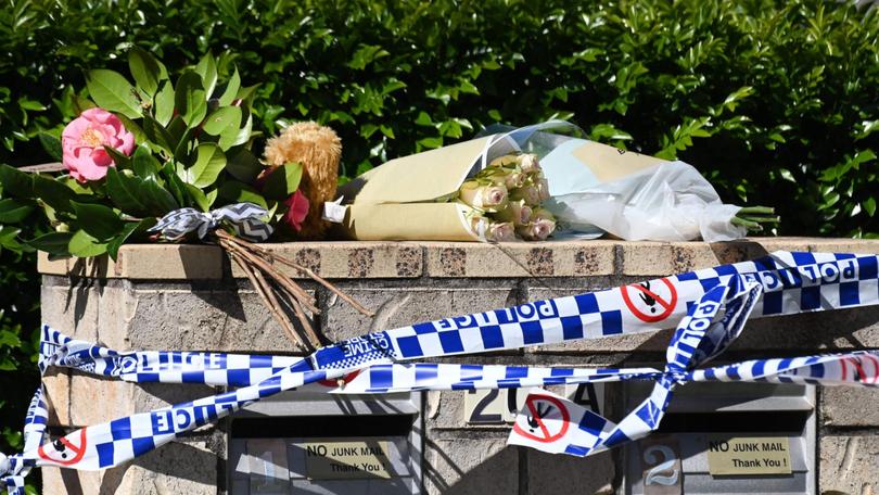 Floral tributes at the Merritt St home in Harristown, Toowoomba, following the house fire which killed three children.