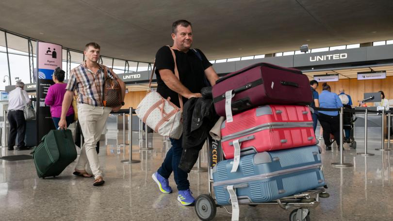 South African refugee Charl Kleinhaus, right, arrives at Dulles International Airport in Virginia on Monday. MUST CREDIT: Craig Hudson/For The Washington Post Craig Hudson