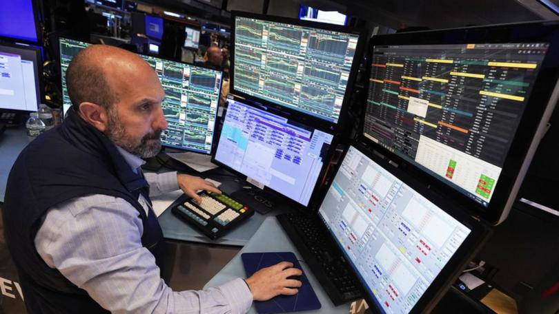 Investors on Wall Street are awaiting comments from at least two Federal Reserve members. (AP PHOTO)