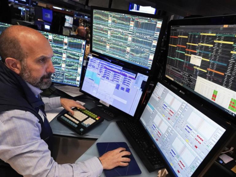 Investors on Wall Street are awaiting comments from at least two Federal Reserve members. (AP PHOTO)