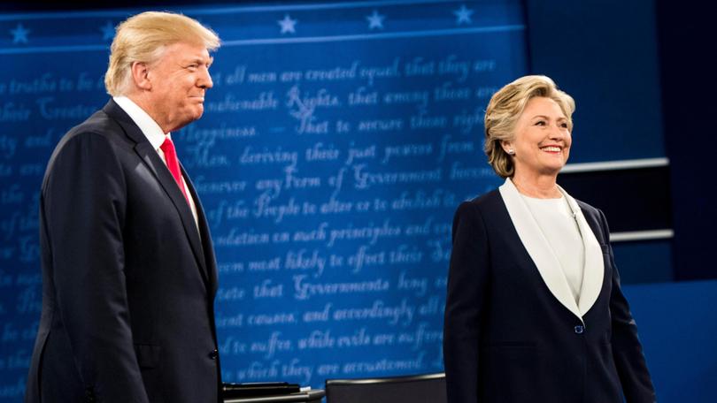 Hillary Clinton and Donald Trump stand onstage for a presidential debate in St. Louis, on Oct. 9, 2016. MUST CREDIT: Melina Mara/The Washington Post)