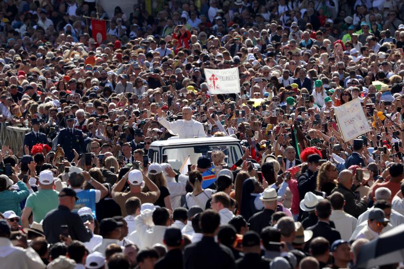 Pope Leo XIV waves as he arrives ahead of the Inauguration Mass of Pope Leo XIV in St Peter's Square.