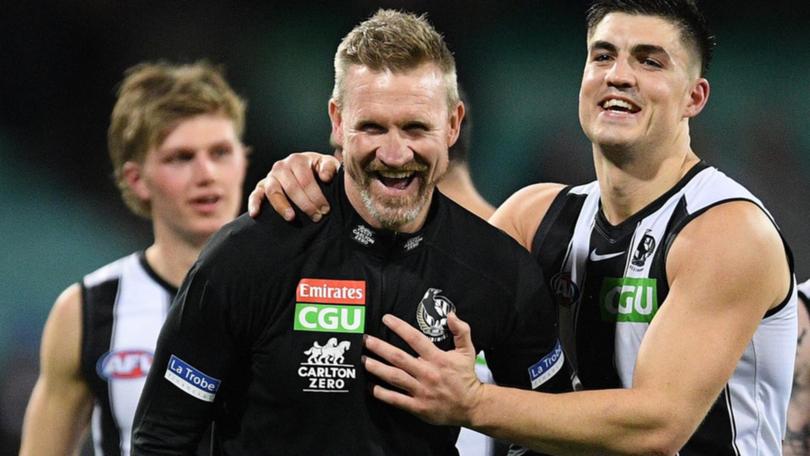 Former Collingwood coach Nathan Buckley (centre) admits he is intrigued by the Tasmania Devils job. (Dean Lewins/AAP PHOTOS)