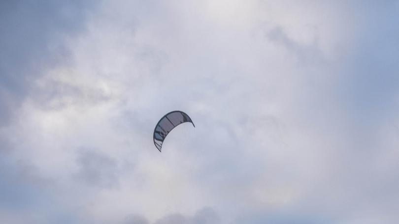 A kitesurfer sustained laceration injuries after a gust of wind lifted him off the surf of Ettalong Beach and into nearby powerlines.
Picture: NewsWire/Flavio Brancaleone