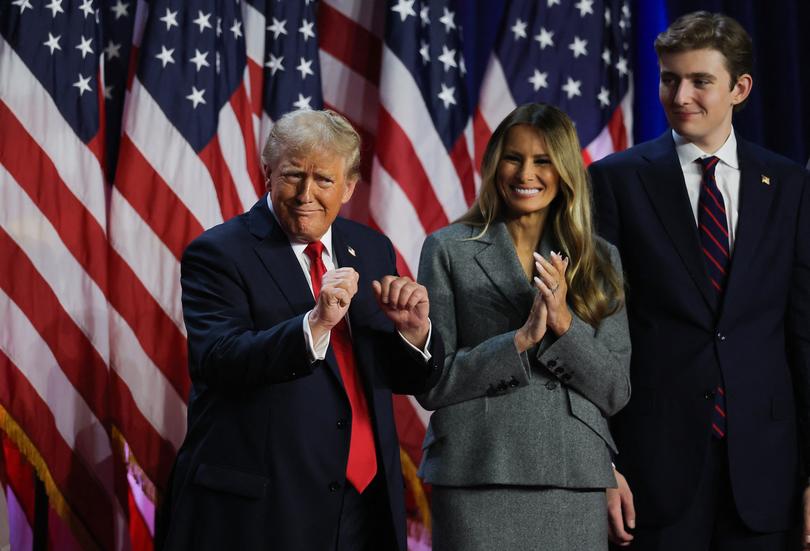 Republican presidential nominee and former U.S. President Donald Trump dances accompanied by Melania Trump and Barron Trump, after speaking following early results from the 2024 U.S. presidential election in Palm Beach County Convention Center, in West Palm Beach, Florida, U.S., November 6, 2024. REUTERS/Carlos Barria