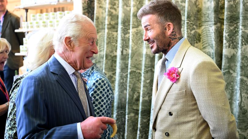 David Beckham wearing a David Austin Roses ‘King's Rose’ speaks with King Charles III.
