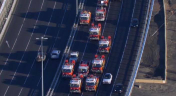 The convoy of firetrucks descend on Parliament House in Melbourne, causing significant traffic delays for commuters.