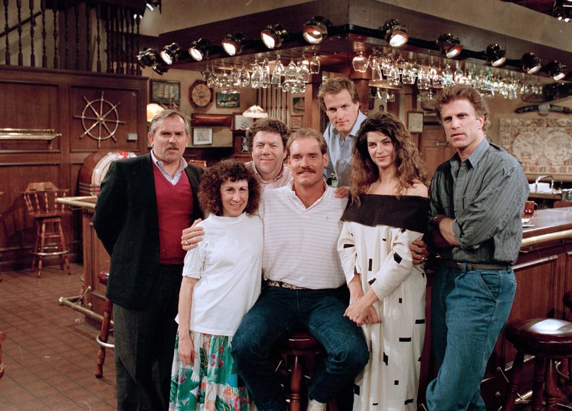 Boston Red Sox third baseman Wade Boggs poses with the cast of Cheers during a rehearsal for an episode in which he appears.