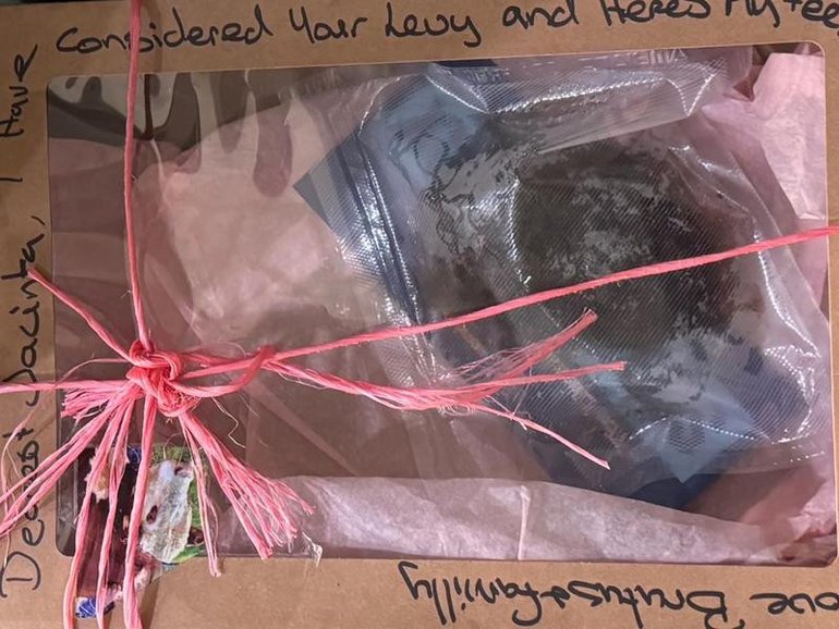 A vacuum-sealed cow dung package, wrapped in pink twine, was left at Premier Jacinta Allan's office.