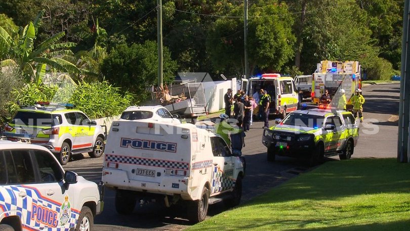The trailer rolled down a hill and trapped the man on Bushmead St at Nerang about 12.10pm on Wednesday.