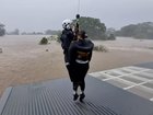 Rescue helicopters are winching people to safety from flooded properties as more rain in forecast.