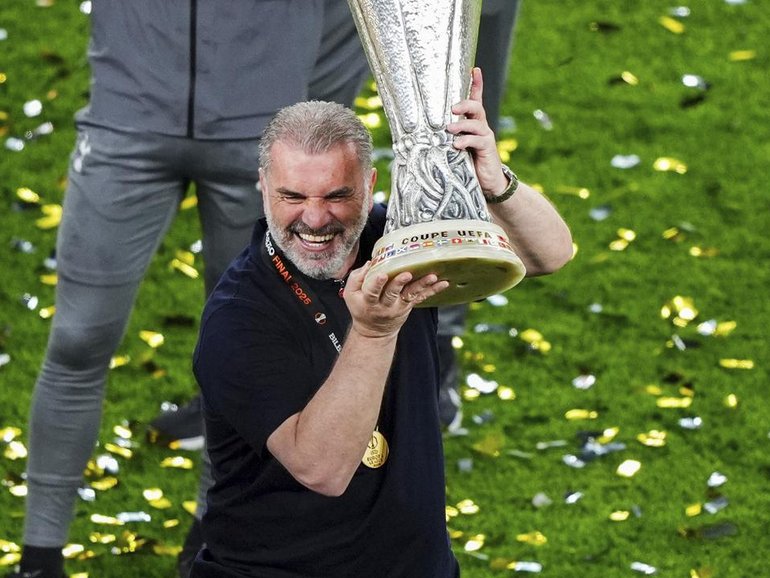 Spurs boss Ange Postecoglou lifts the Europa League trophy after they downed Manchester United.
