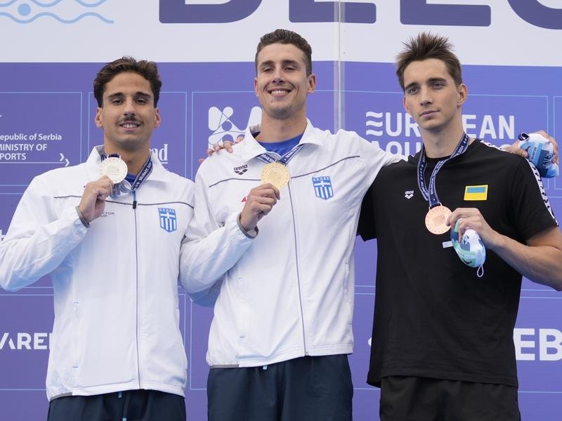 Kristian Gkolomeev (c) says there are three reasons he joined James Magnussen in Enhanced Games. (AP PHOTO)