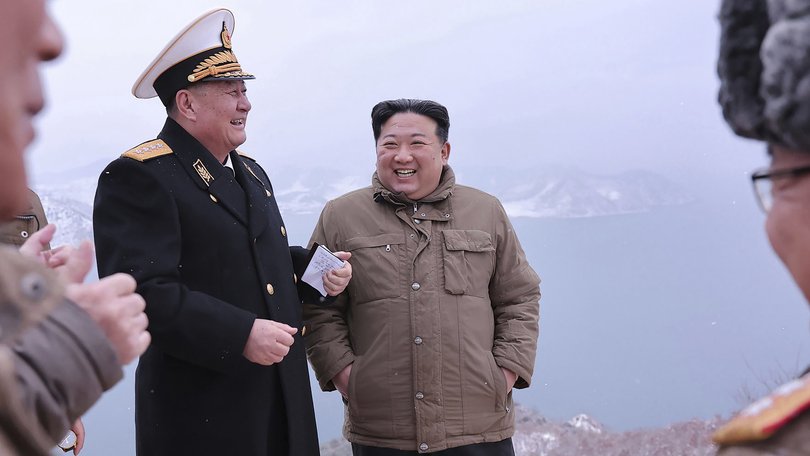 North Korean leader Kim Jong Un, right, stands with a North Korean navy commander.
