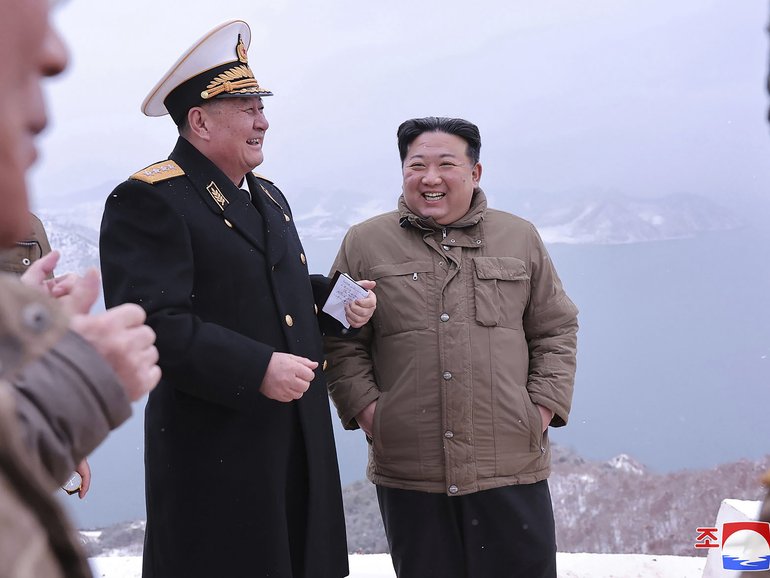  North Korean leader Kim Jong Un, right, stands with a North Korean navy commander.