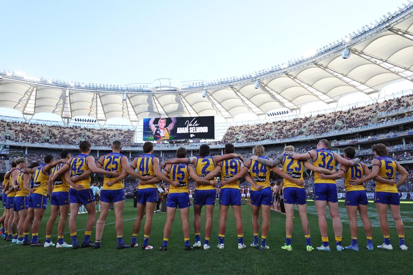 Eagles’ players stop for Adam Selwood.