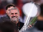 Ange Postecoglou celebrates with the UEFA Europa League trophy.
