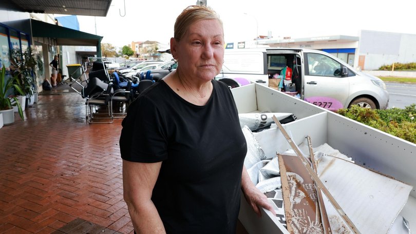 Taree resident Marlene Masters cleans up after floodwaters devastated Mid North Coast communities in NSW. Picture: NewsWire / Scott Calvin