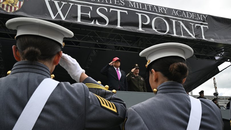 President Donald Trump, centre, salutes before speaking to US Military Academy graduating class of cadets during commencement ceremonies in West Point, NY.
