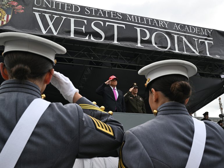 President Donald Trump, centre, salutes before speaking to US Military Academy graduating class of cadets during commencement ceremonies in West Point, NY.