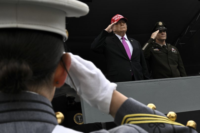 President Donald Trump salutes a cadet after delivering his speech.