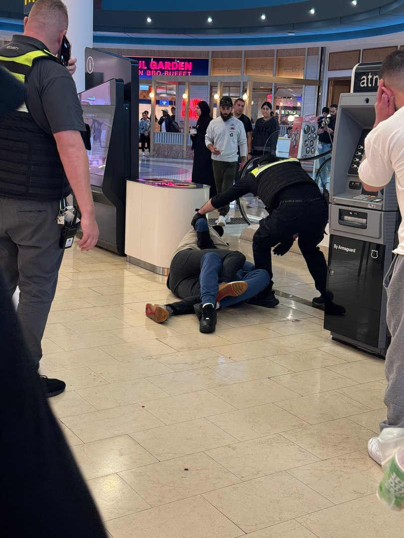 A shopper pinning one of the men to ground during the shopping centre brawl.