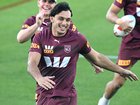 Tino Fa'asuamaleaui shares a laugh with teammates during a Queensland training session.