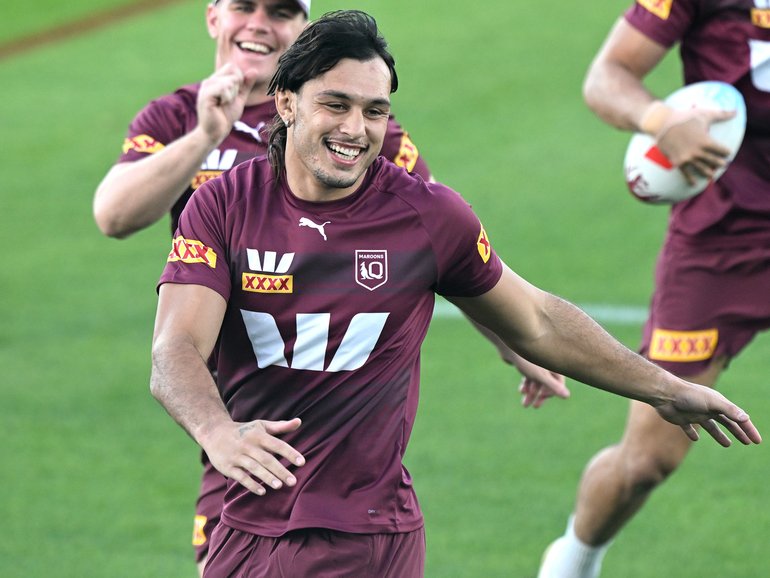 Tino Fa'asuamaleaui shares a laugh with teammates during a Queensland training session.
