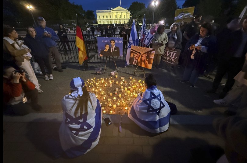 People gather to light candles in a makeshift memorial to honor Yaron Lischinsky and Sarah Milgrim who were killed as they left an event at the Capital Jewish Museum in Washington.