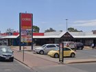 A man has died in police custody at a Coles supermarket in an Alice Springs shopping centre on Tuesday.