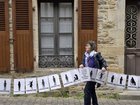 Banners representing each of the 299 abuse victims of a French surgeon were held up outside court. (AP PHOTO)
