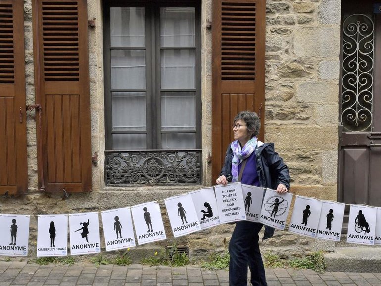 Banners representing each of the 299 abuse victims of a French surgeon were held up outside court. (AP PHOTO)