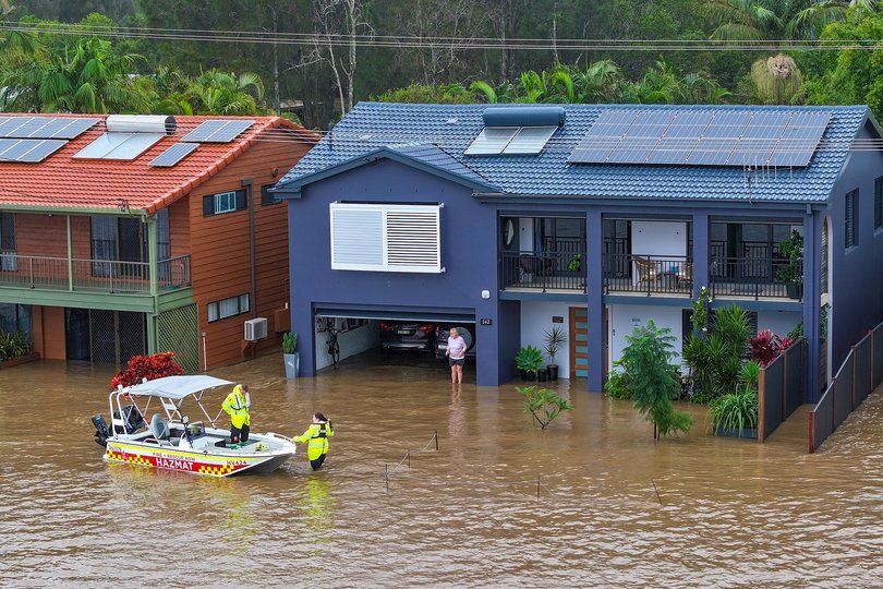 An aerial photo shows NSW Fire Rescue personnel assisting an elderly resident during flooding in Port Macquarie, New South Wales, Thursday, May 22, 2025. A slow-moving trough is dumping rain along the east coast of Australia, leaving thousands of people stranded (AAP Image/Lindsay Moller) NO ARCHIVING