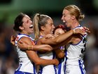 Bella Eddey, Alice O'Loughlin, Jenna Bruton and Kate Shierlaw celebrate during the 2024 AFLW grand final.