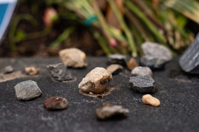 Scattered stones around a makeshift memorial outside the museum.