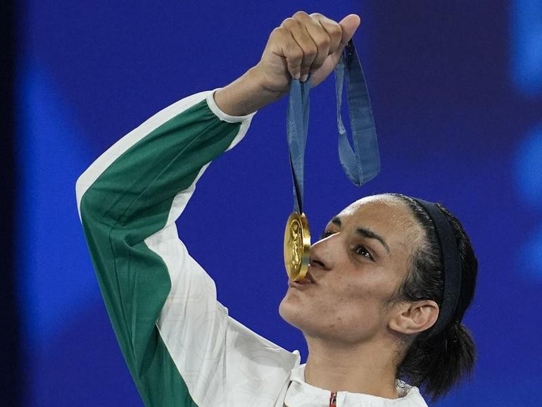 Imane Khelif kisses her medal after winning the women's 66 kg final at the 2024 Olympics.
