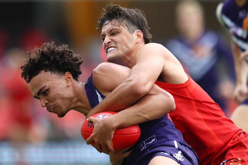 GOLD COAST, AUSTRALIA - MAY 31: Joshua Draper of the Dockers is tackled by Ned Moyle of the Suns during the round 12 AFL match between Gold Coast Suns and Fremantle Dockers at People First Stadium, on May 31, 2025, in Gold Coast, Australia. (Photo by Chris Hyde/Getty Images via AFL Photos)