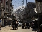 Smoke billows in the distance as Palestinians in Jabalia fled on Friday, May 30, 2025, after the Israeli military issued a sweeping new evacuation order for much of northern Gaza. 