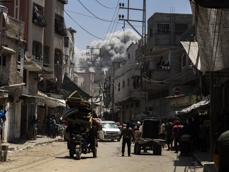 Smoke billows in the distance as Palestinians in Jabalia fled on Friday, May 30, 2025, after the Israeli military issued a sweeping new evacuation order for much of northern Gaza. 