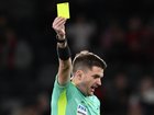 Two men have been charged after allegedly manipulating yellow card calls in the A-League. 