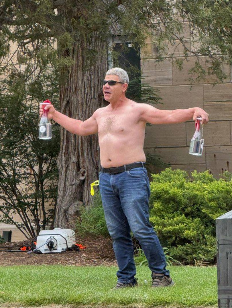 A topless man allegedly launched Molotov cocktails/