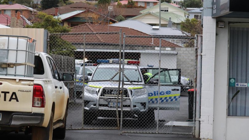 Police are investigating the discovery of a man's body in a bin at the rear of a business in Hobart.