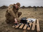 Dmytro Romanchenko, 22, director of Raptor Engineering, adjusts parts of fps front before flying  a fiberoptic controlled FPV drone from a launch pad.