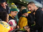 Milos Degenek of the Socceroos signs autographs at HBF Park on Monday evening.