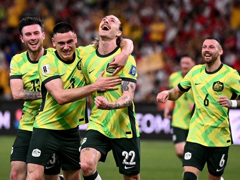 Jackson Irvine of the Socceroos (centre) celebrates with teammates after scoring a goal during the 2026 FIFA men's World Cup qualifier match between Australia and Indonesia at Allianz Stadium in March.
