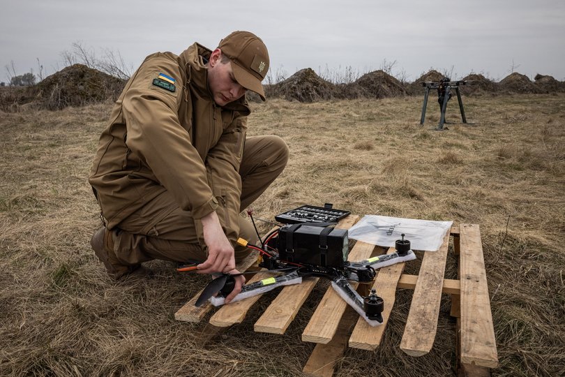An engineer adjusts parts of fps front before flying a fiberoptic controlled FPV drone from a launch pad at a test site in central Ukraine.